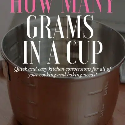 How Many Grams In A Cup pin with text over vignette with measuring cup in background.