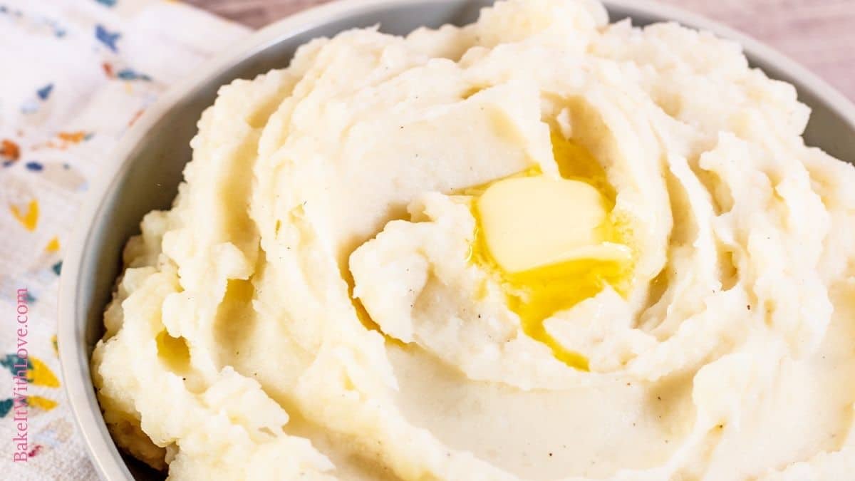 Wide closeup on the top of the Instant Pot mashed potatoes in a serving bowl.