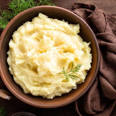 Delicious, fluffy instant pot mashed potatoes served in wooden bowl.