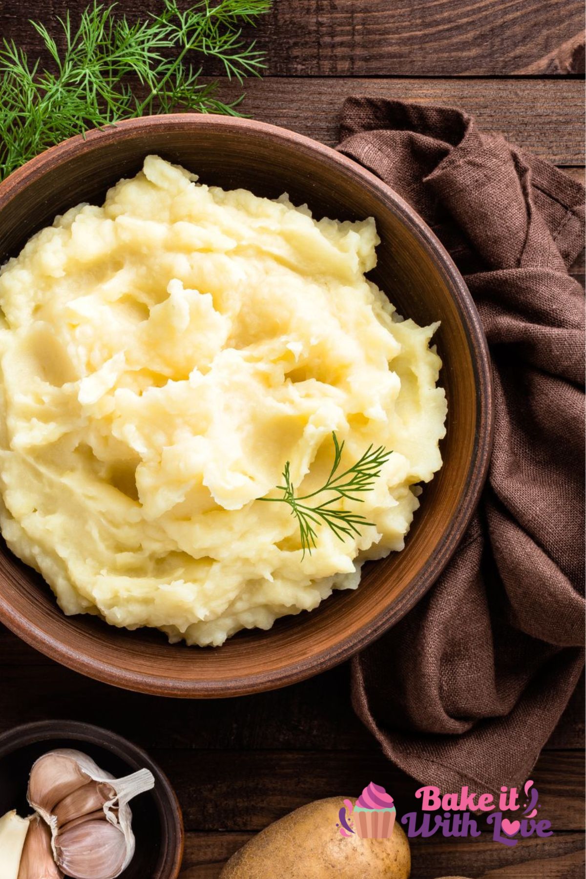 Tall overhead of the dished up Instant Pot mashed potatoes garnished with dill sprig.