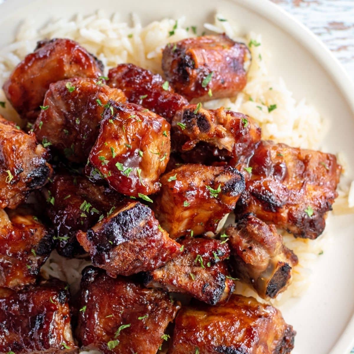 Pork rib tips vs pork riblets image with overhead image of bbq pork rib tips on rice.