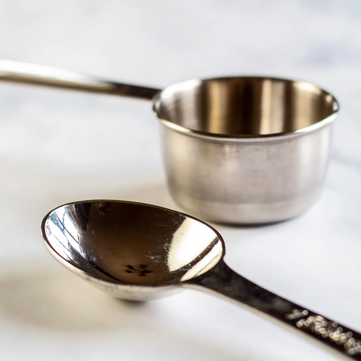 How many tablespoons in a ¼ cup with a side by side comparison of the two measuring units.