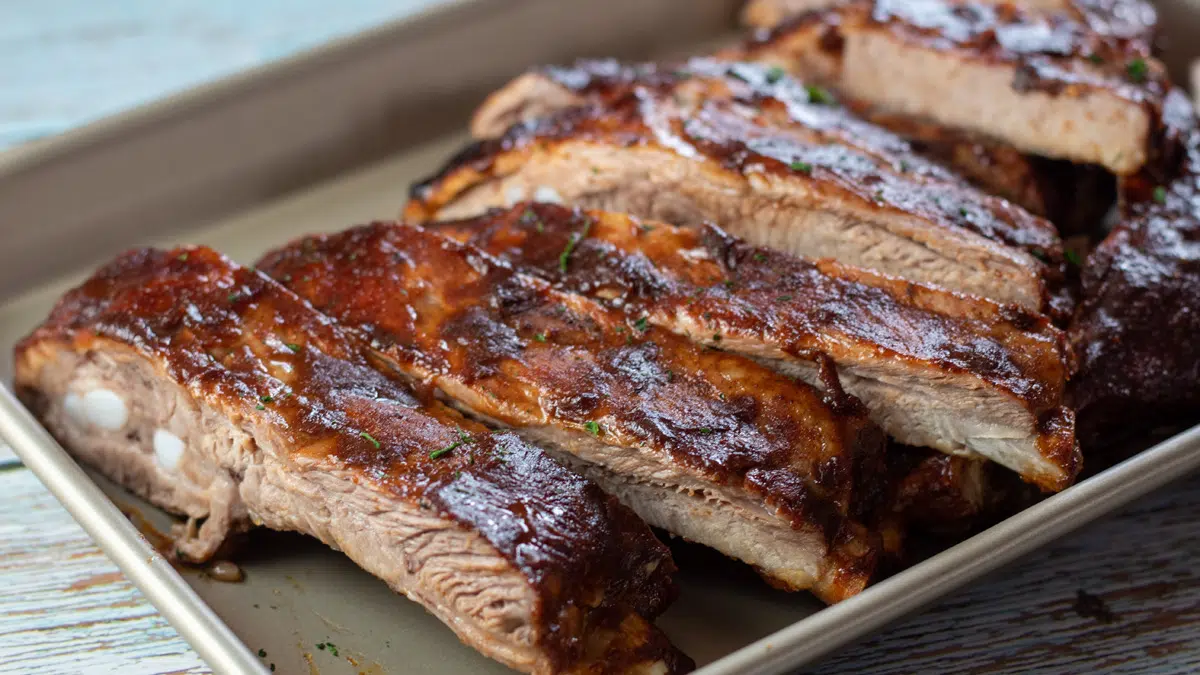 Wide image of baked bbq pork spare ribs.