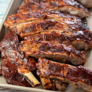 Square image of baked bbq pork spare ribs.