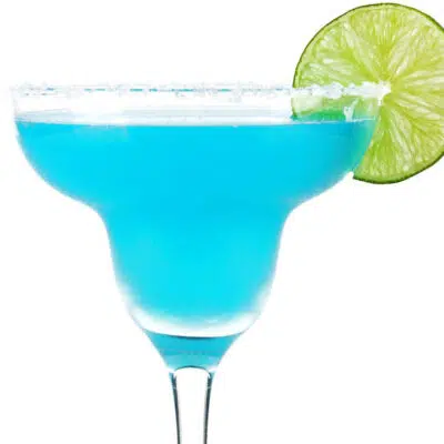 Square image of a blue margarita with lime.