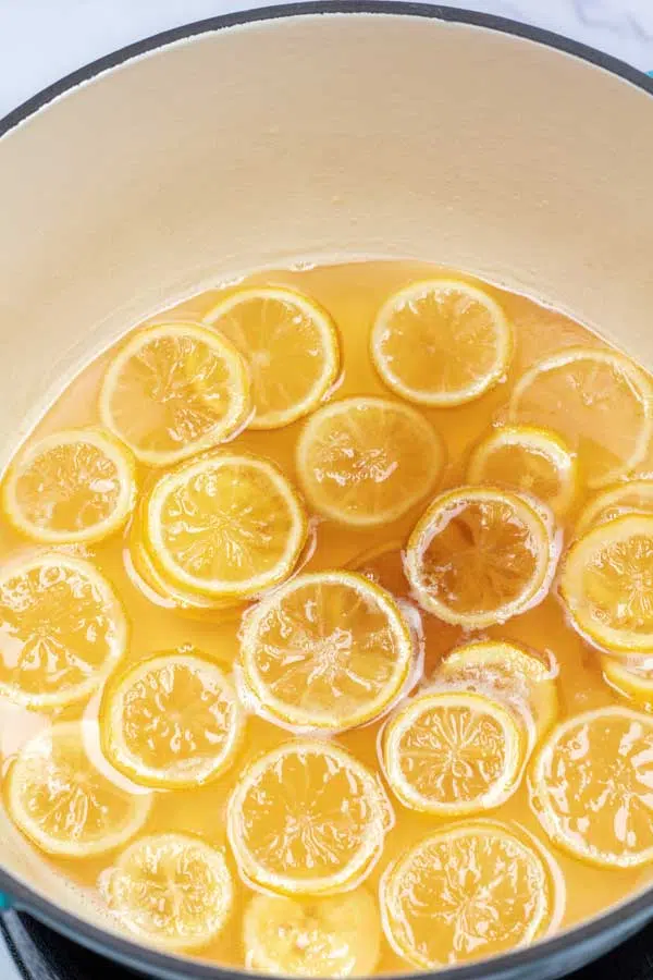 Process image 4 showing sliced lemons in a pot cooking with added vanilla.