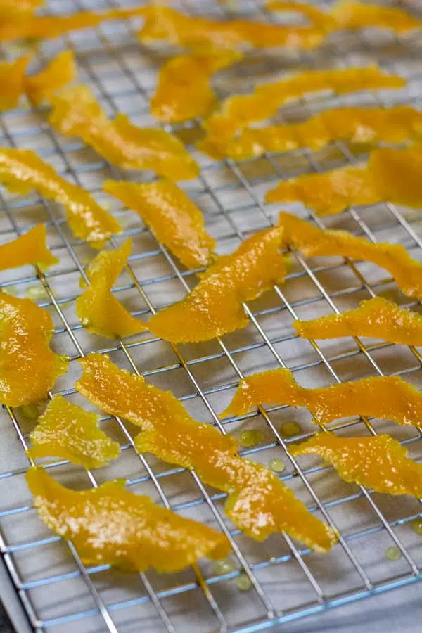Process photo 6 transfer candied orange peel to wire rack to dry.