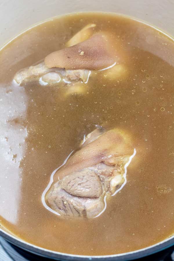 Process photo 2 showing ham hocks cooked in broth.
