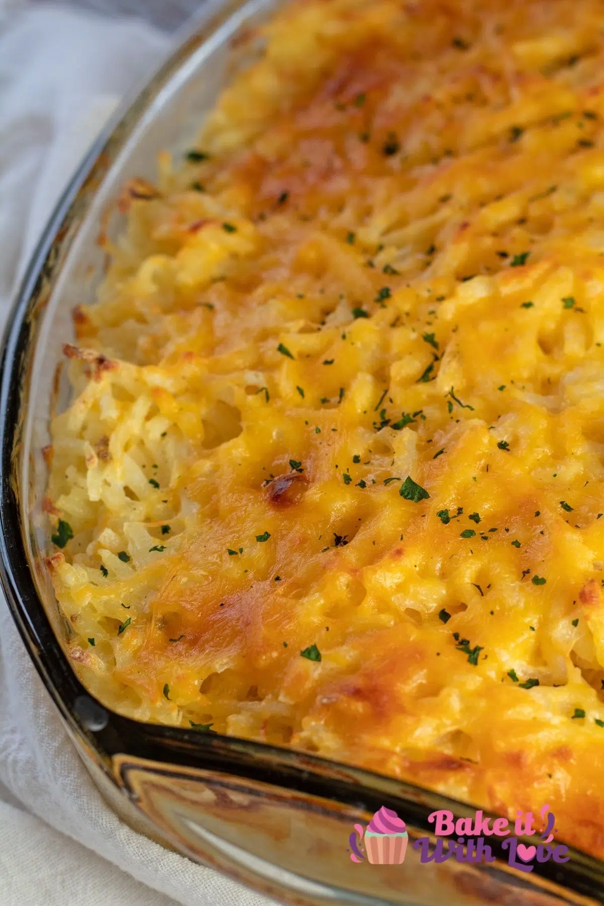 Tall image of Cracker Barrel Hashbrown casserole copycate in a glass baking dish.