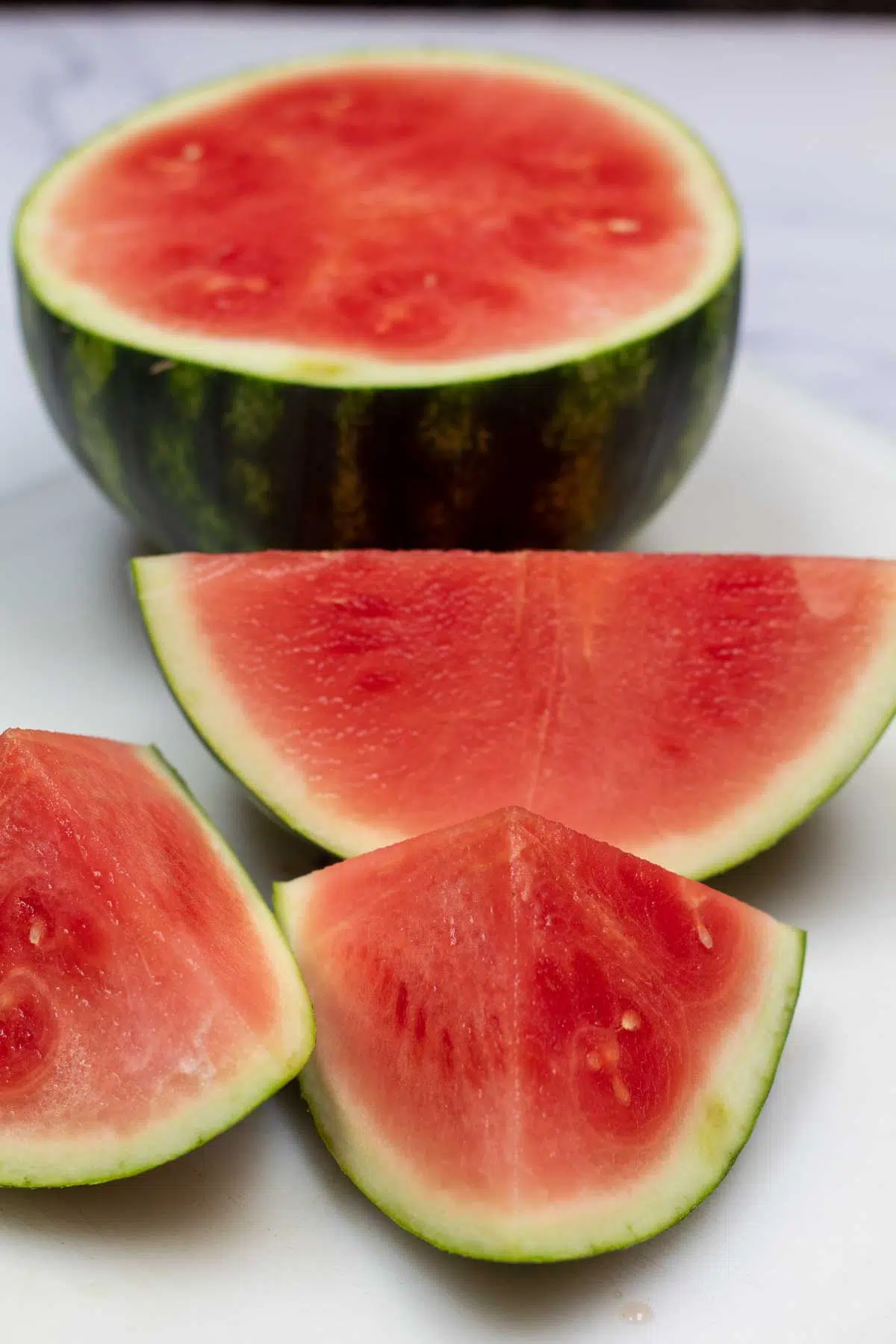 Dehydrated watermelon jerky ingredients image with sliced watermelon, no optional ingredients like salt, sugar, Tajin, or mint shown.