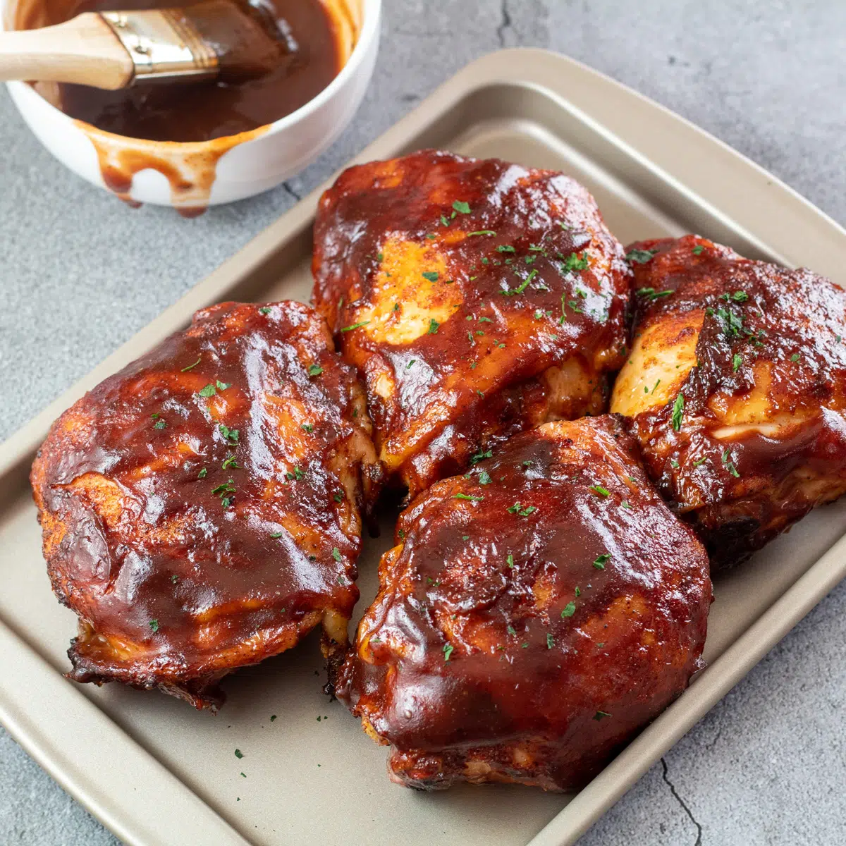 Square image of bbq grilled chicken thighs.