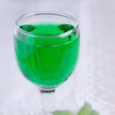 Square image of a creme de menthe substitute in a glass.