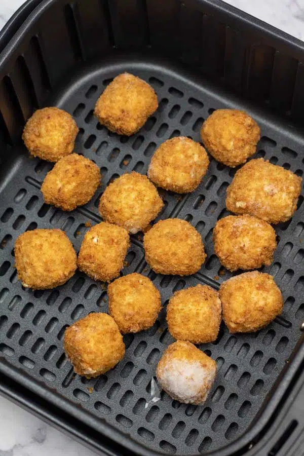 Process image 1 showing mac & cheese bites in the air fryer basket.