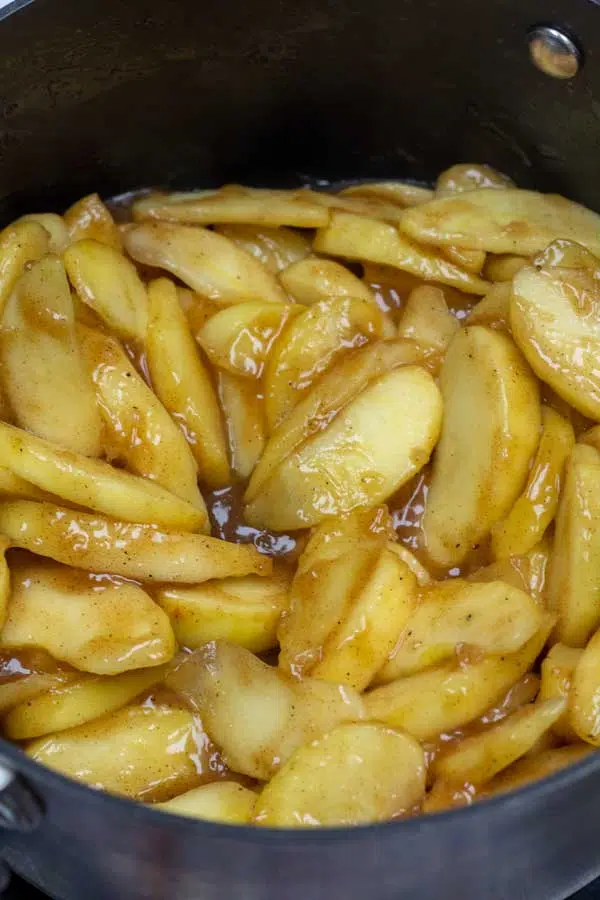 Process image 8 showing cooked and thickened apple pie filling in sauce pot.