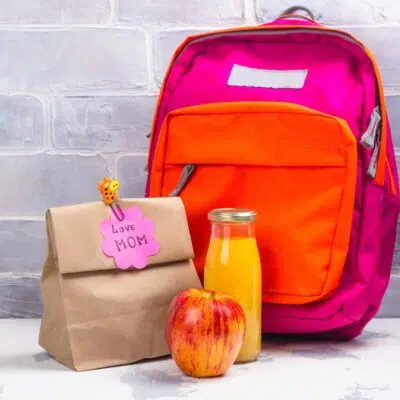 Square image of kids backpack and lunch bag.