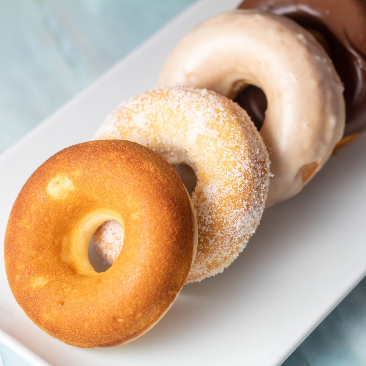 पके हुए डोनट्स के वर्गीकरण की चौकोर छवि।