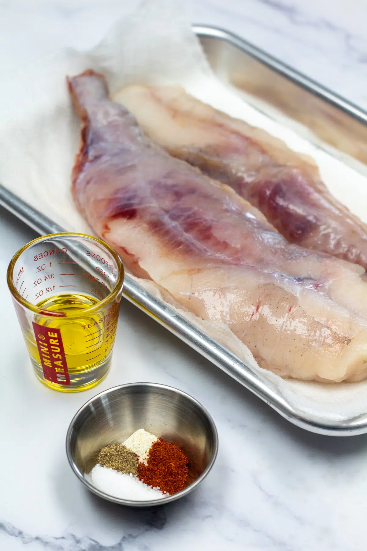 Tall photo showing ingredients for baked monkfish.