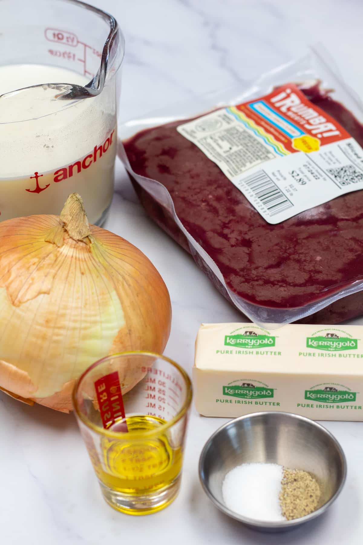 Tall image showing ingredients needed for beef liver and onions.
