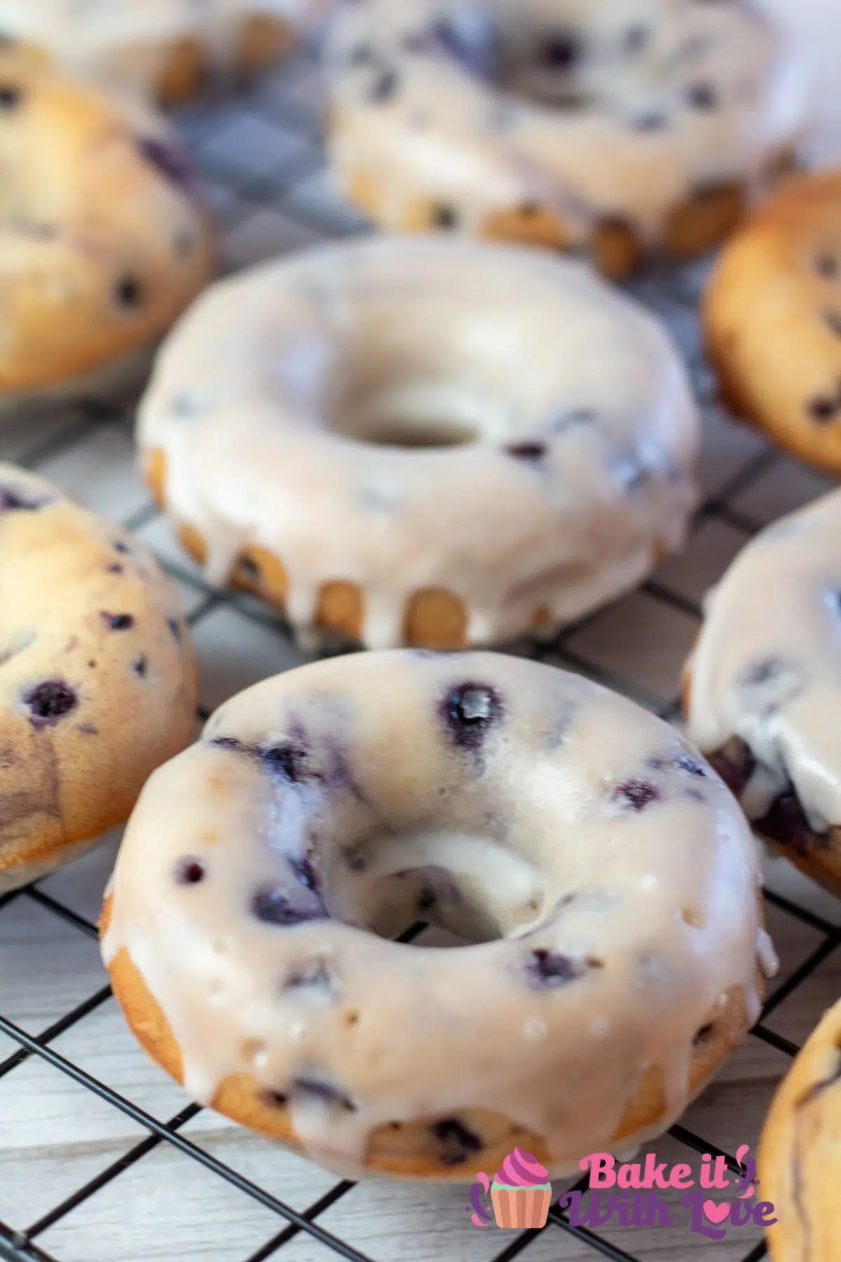 Tall image of baked blueberry donuts.