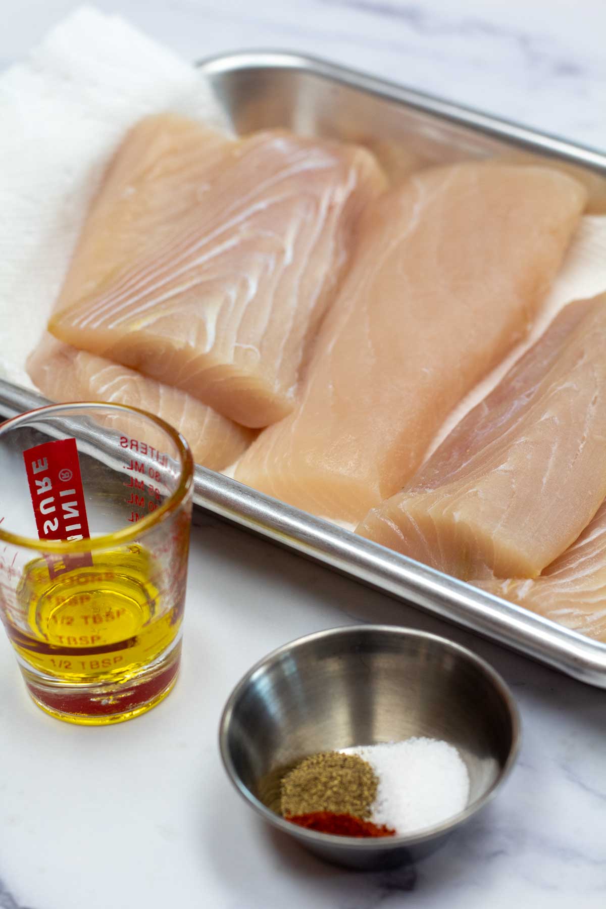 Tall image showing all the ingredients for broiled mahi mahi.