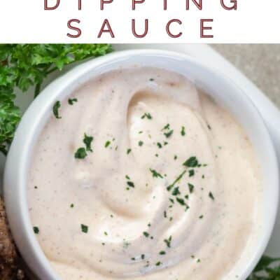Pin image with text of a small bowl of cajun dipping sauce.