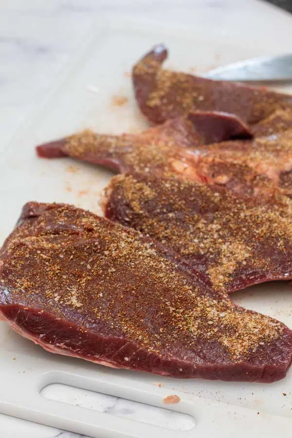 Process image 5 showing seasoned beef heart steaks.