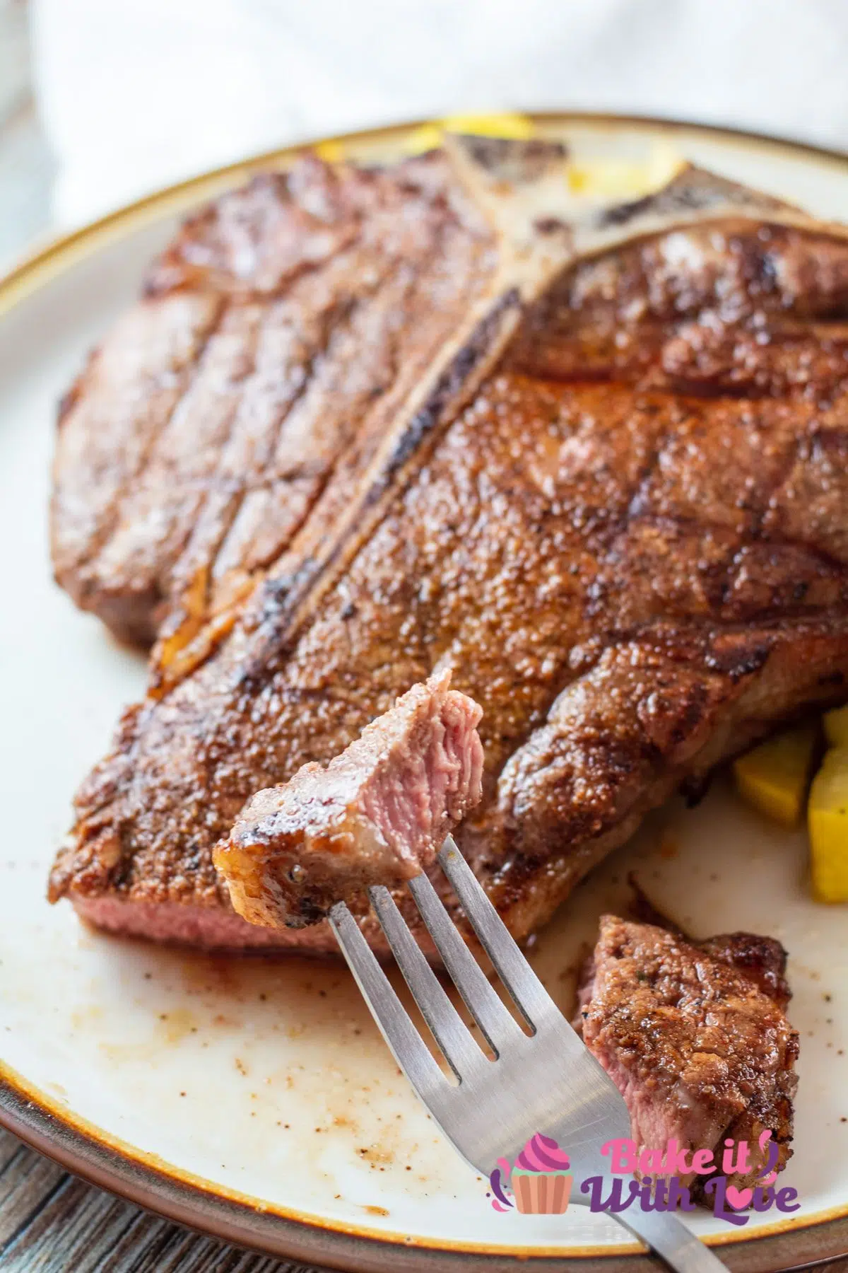 Tall image of a grilled t bone steak on a plate.