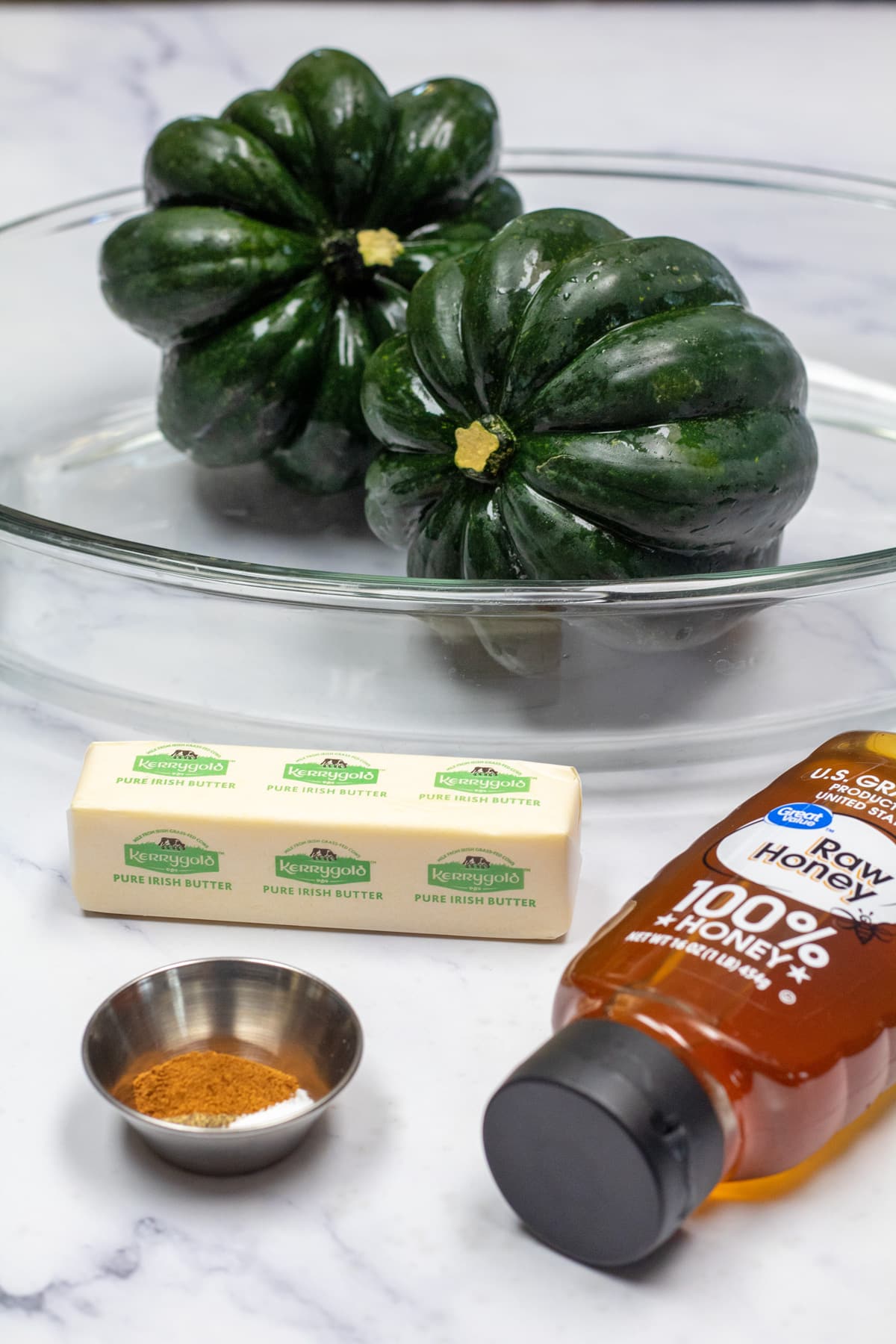 Tall image showing ingredients needed for honey roasted acorn squash.