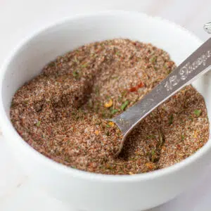 Square image of Jamaican jerk seasoning in a white bowl.