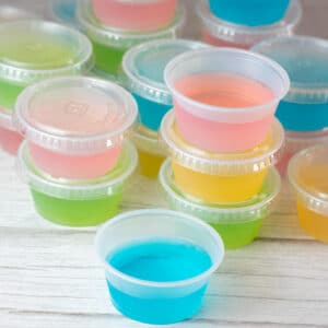 Square image of multi colored jello shots.