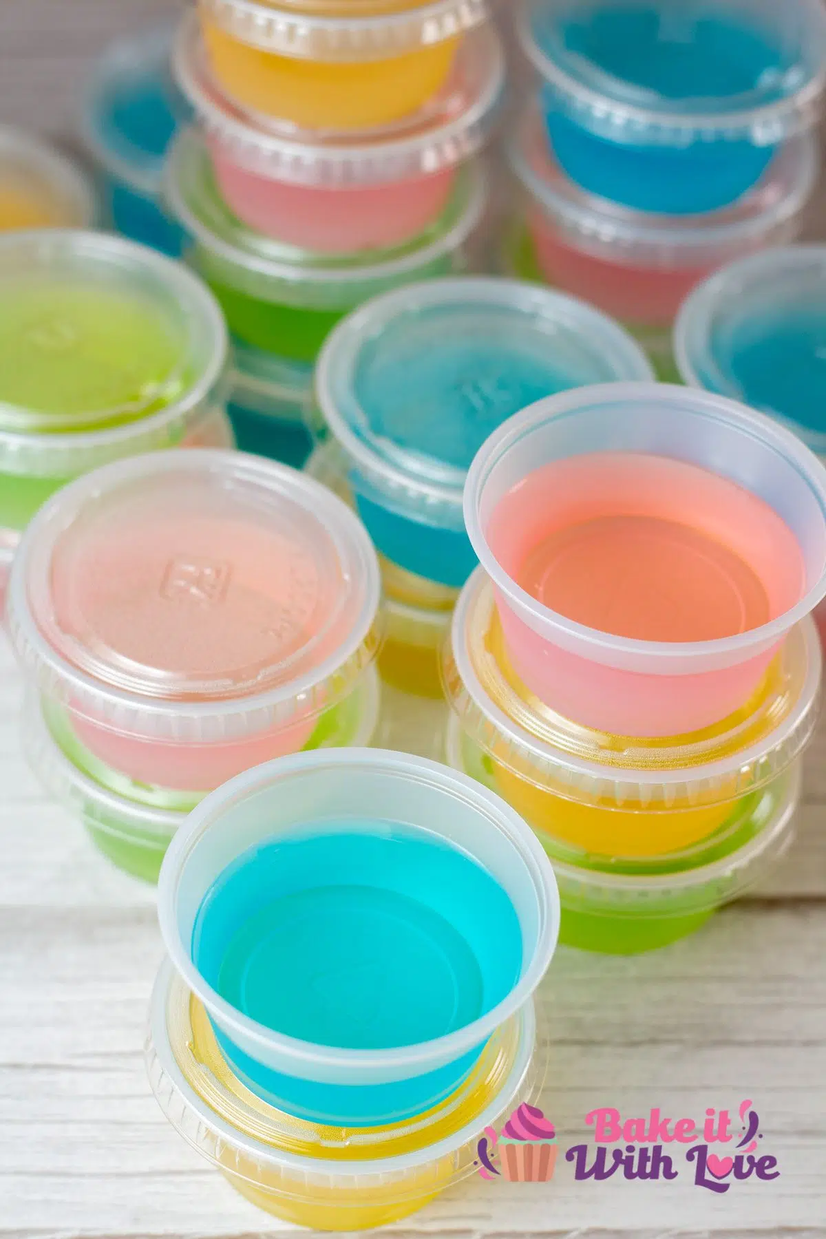 Tall image of multi colored jello shots.