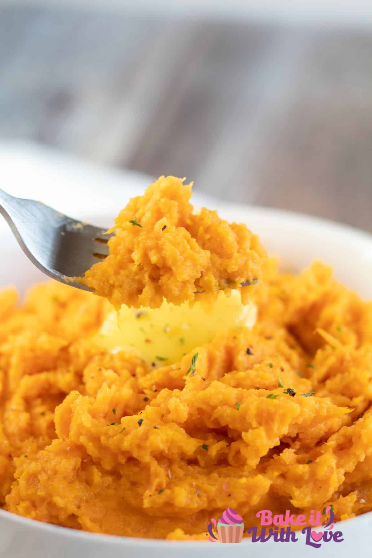 Tall image of mashed sweet potatoes in a white bowl.