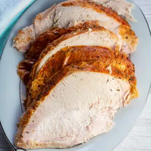 Easy oven roasted turkey breast sliced and served on platter.