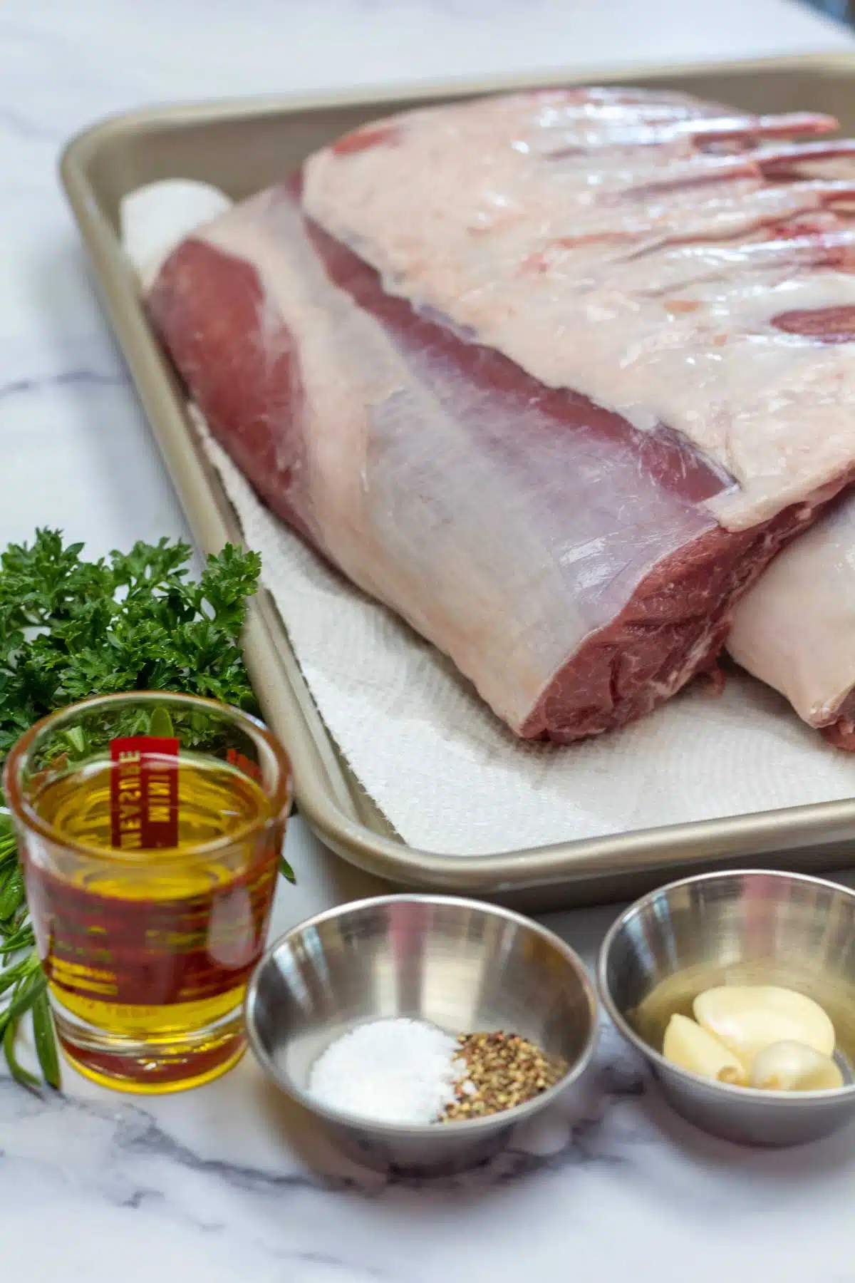 Tall image showing ingredients for rack of lamb.