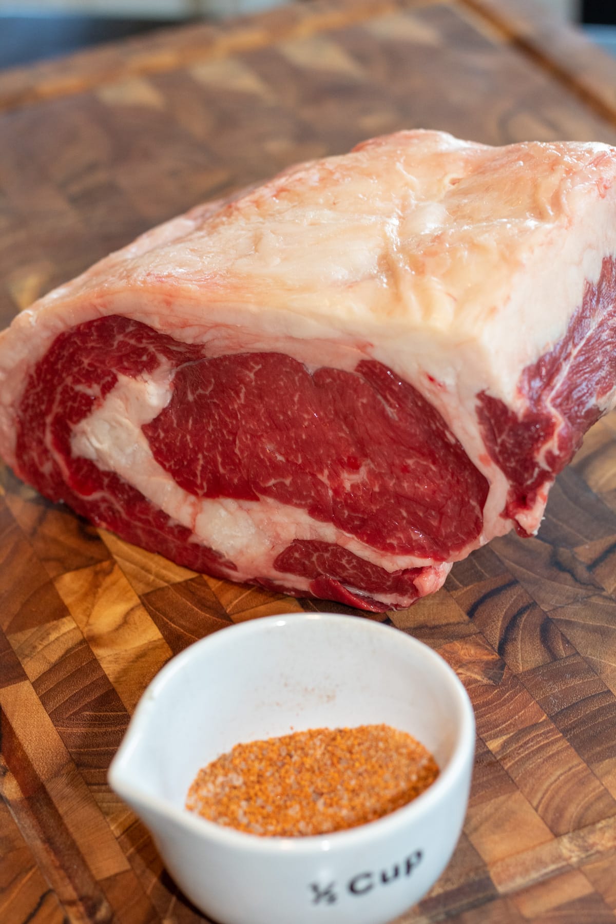 SMoked bison prime rib recipe ingredients including a beautiful cut of aged buffalo and seasoning.