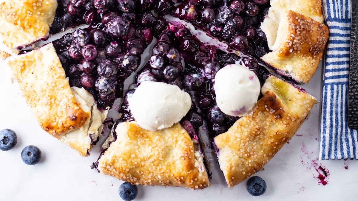 Overhead view of a sliced half of my freshly baked blueberry galette.