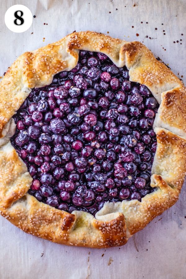 Blueberry galette process photo 8 baked galette on the parchment paper-lined baking sheet.