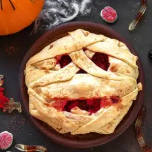 Overhead of the best Halloween mummy pie with eyes and bloody mouth.