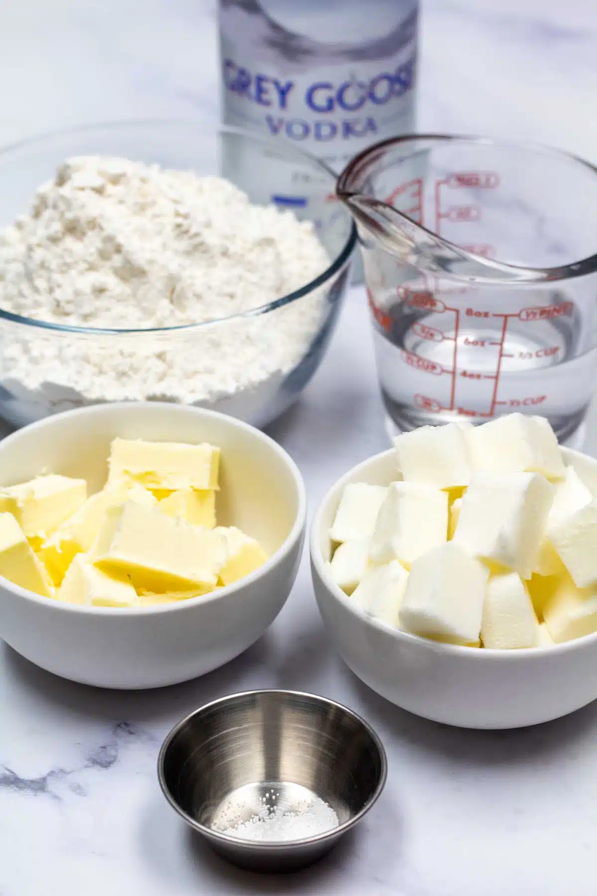 Tall image showing ingredients for the best pie dough.
