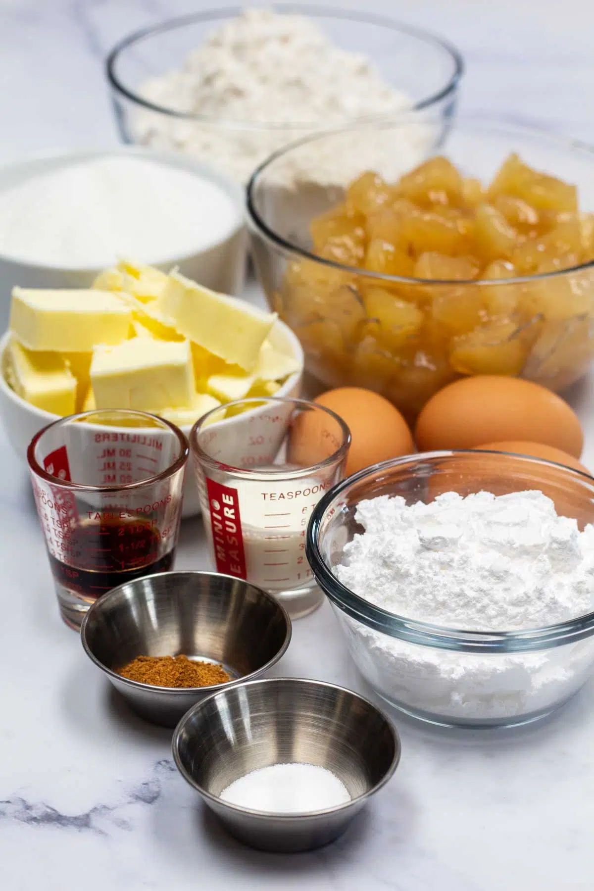 Tall image of ingredients needed for apple cobbler bars.