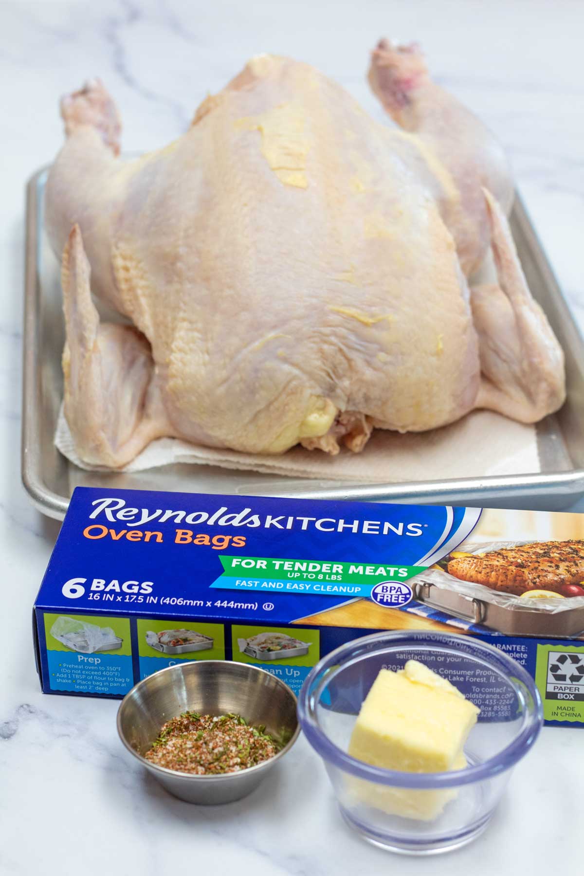 Tall image of ingredients needed for bag roasted chicken.