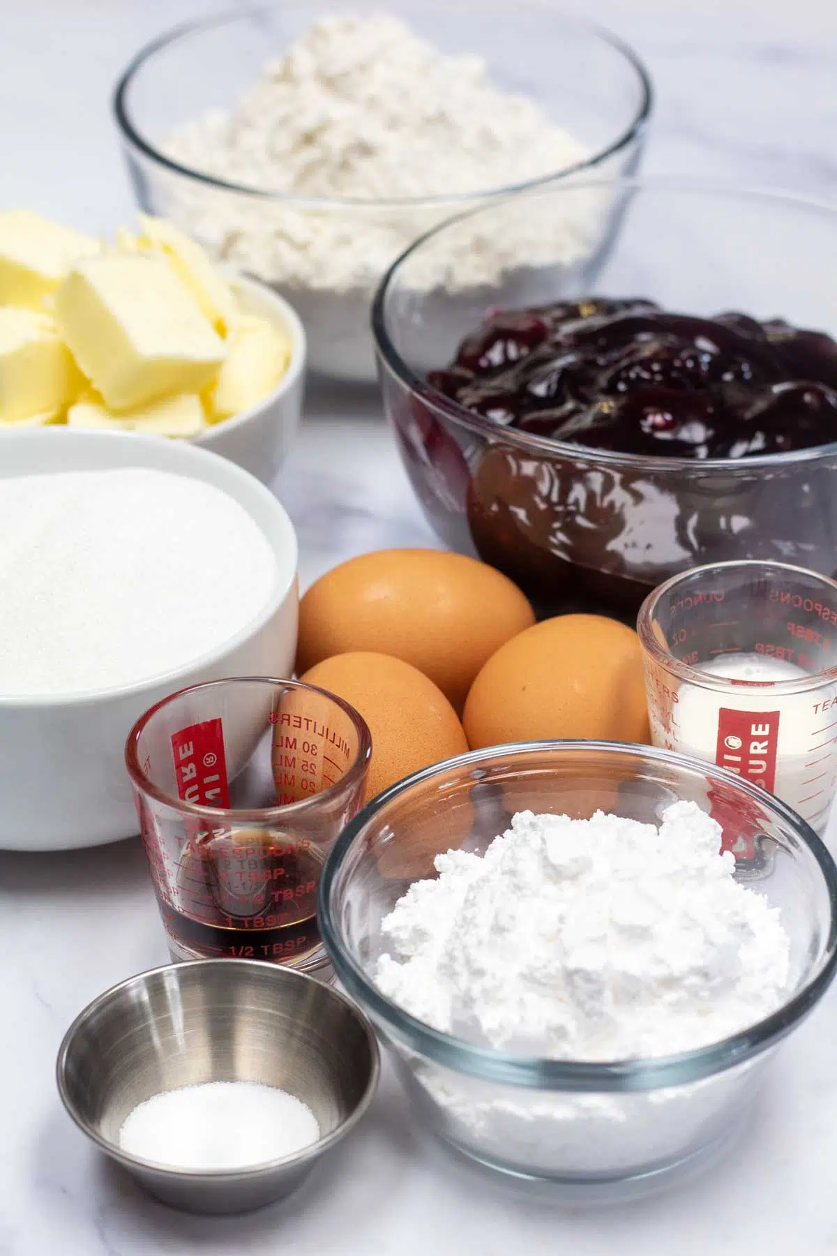 Tall image of ingredients needed for blackberry pie bars.
