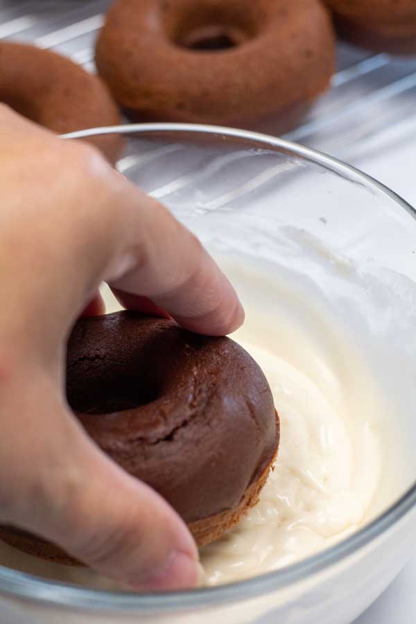 Process image 10 showing dipping baked donuts in icing.