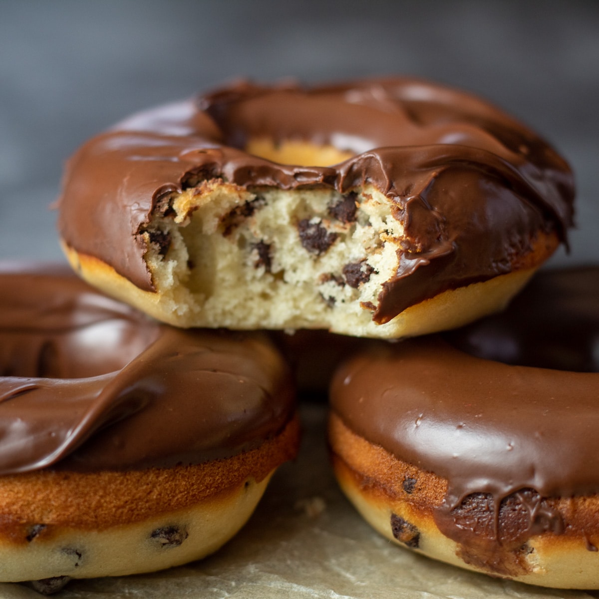 Square image of chocolate chip baked donuts.