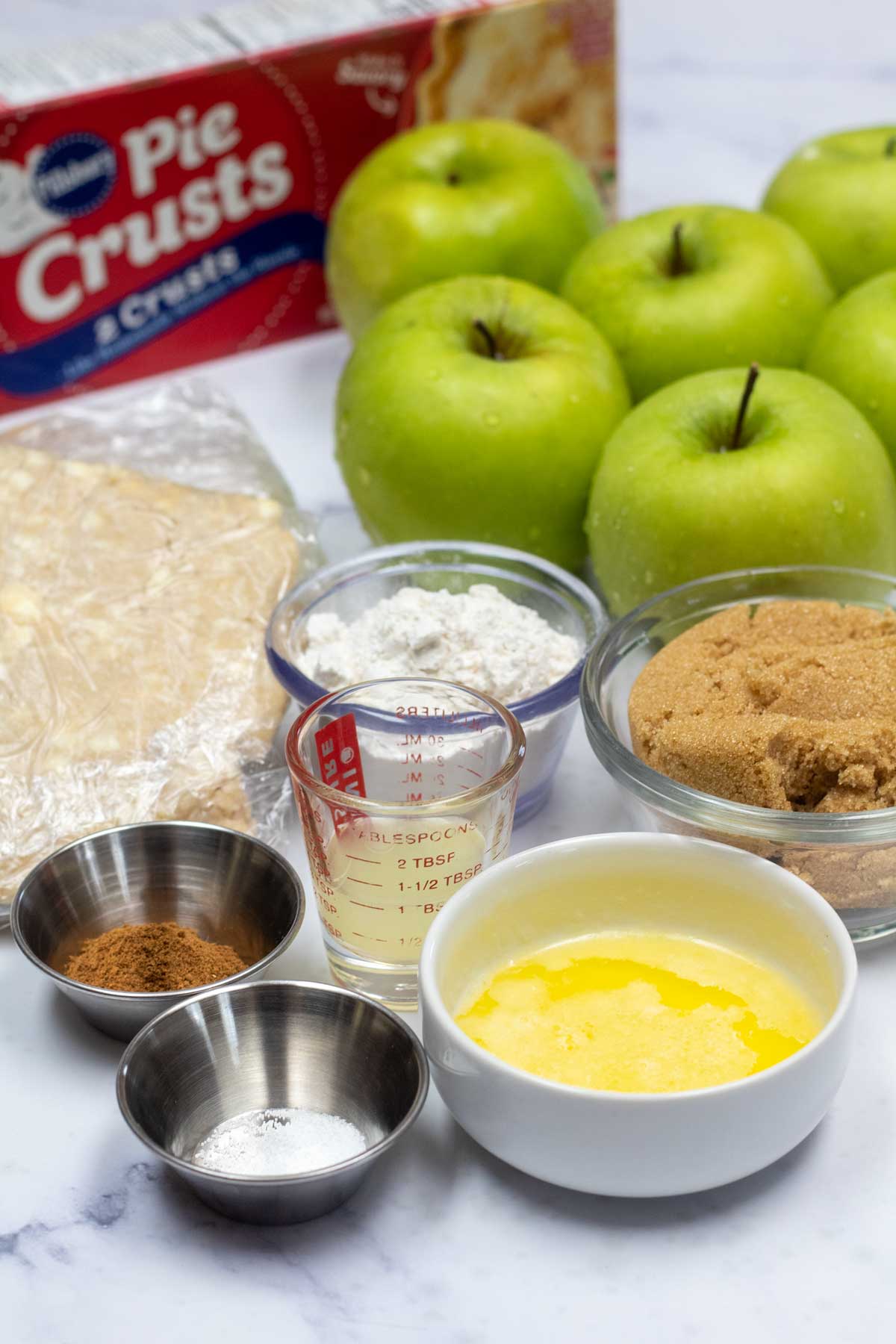 Tall image showing ingredients needed for Granny Smith apple pie.