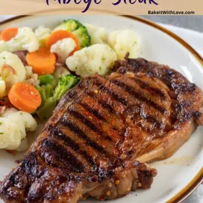 Pin image with text of a grilled ribeye steak on a plate with mixed veggies.