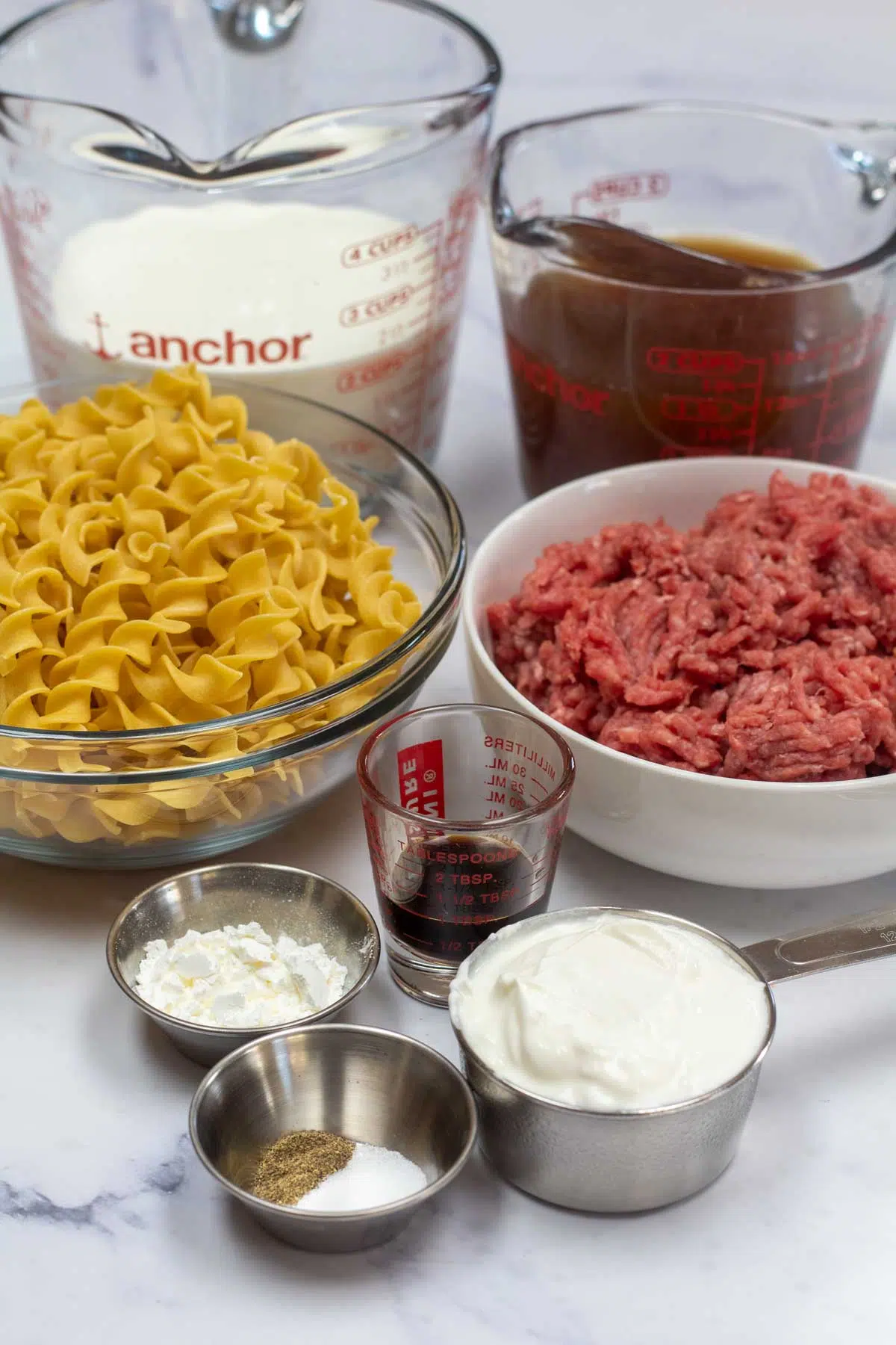 Tall image of ingredients needed for hamburger helper beef stroganoff.