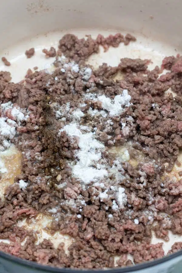 Process image 2 showing browned ground beef and seasoning in skillet.