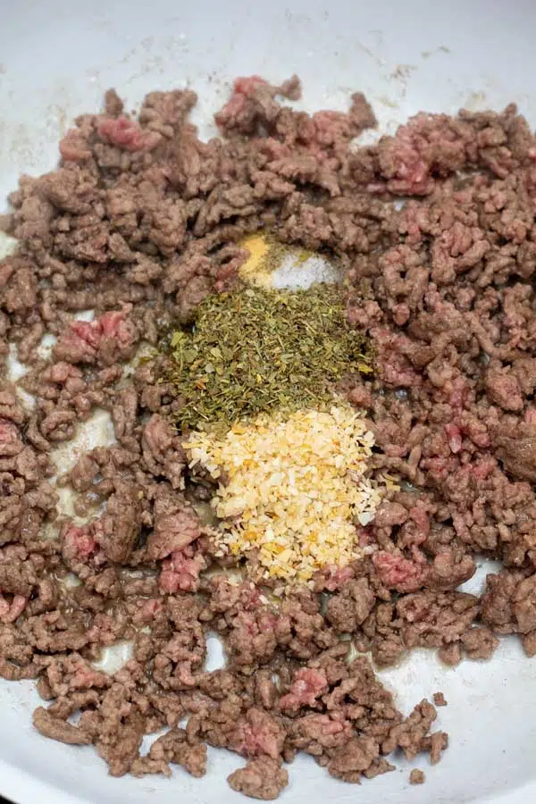 Process image 2 showing browned ground beef in a skillet with seasoning.