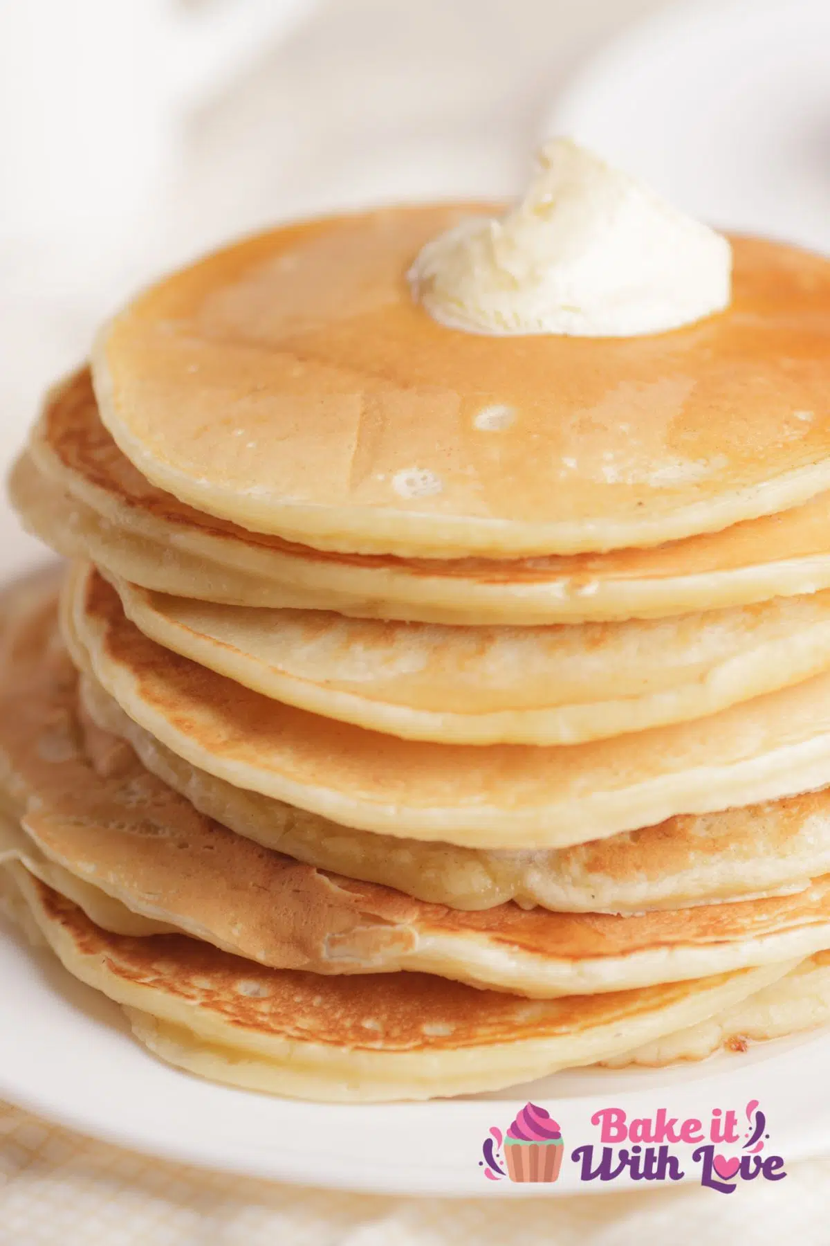 Tall image of a stack of homemade pancakes.